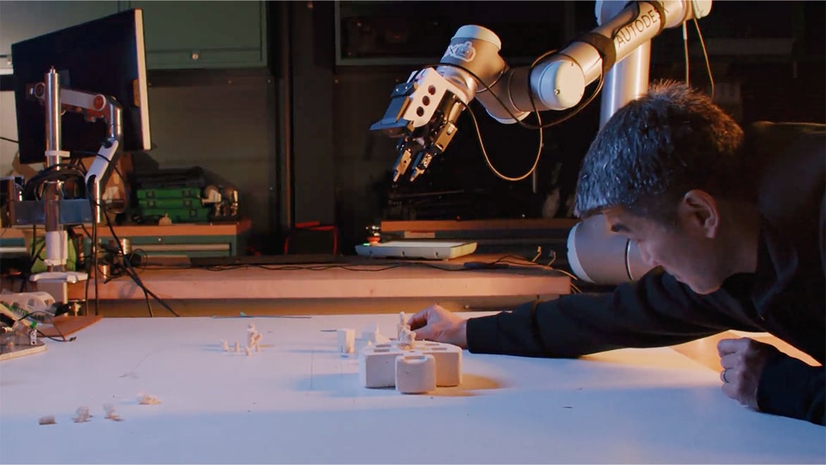 A man using AI-powered robotics at Autodesk Technology Center in San Francisco to create coral skeleton mold.