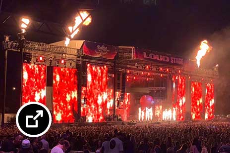 Fiery stage against a dark sky at Rolling Loud hip-hop festival