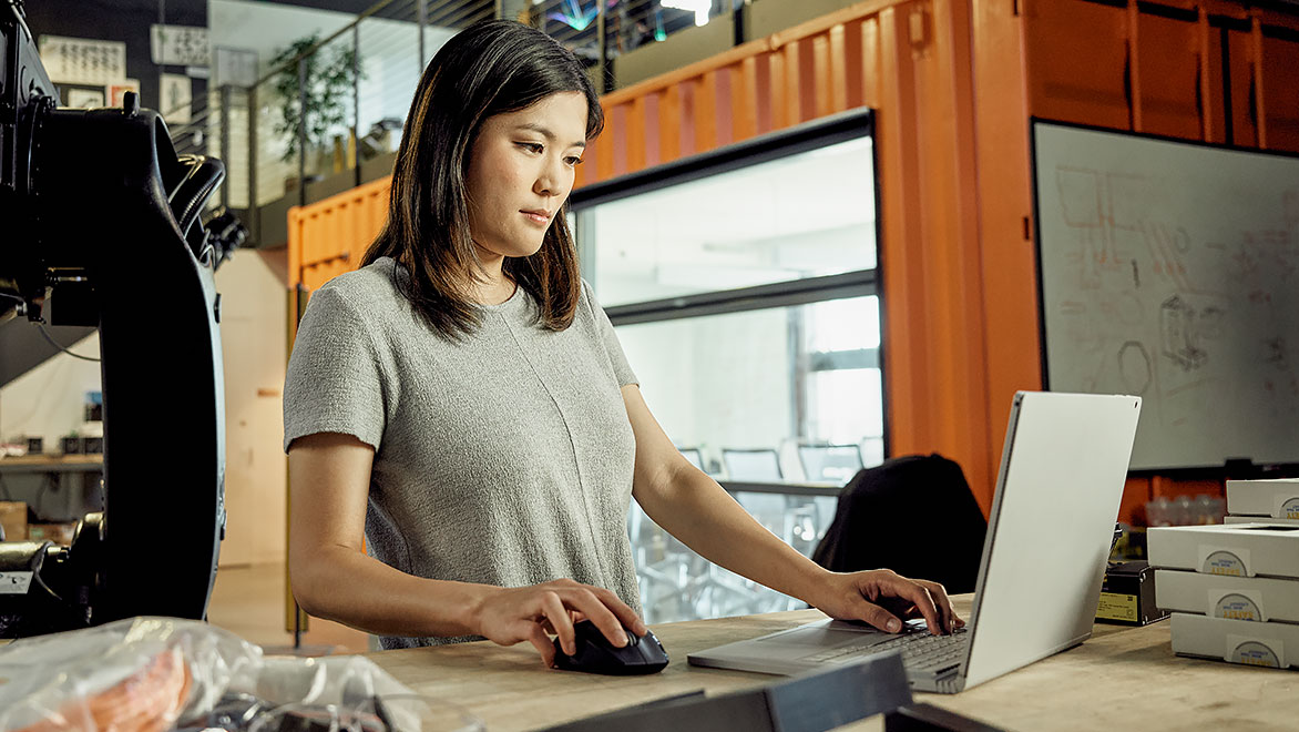 Woman working on a laptop in an office